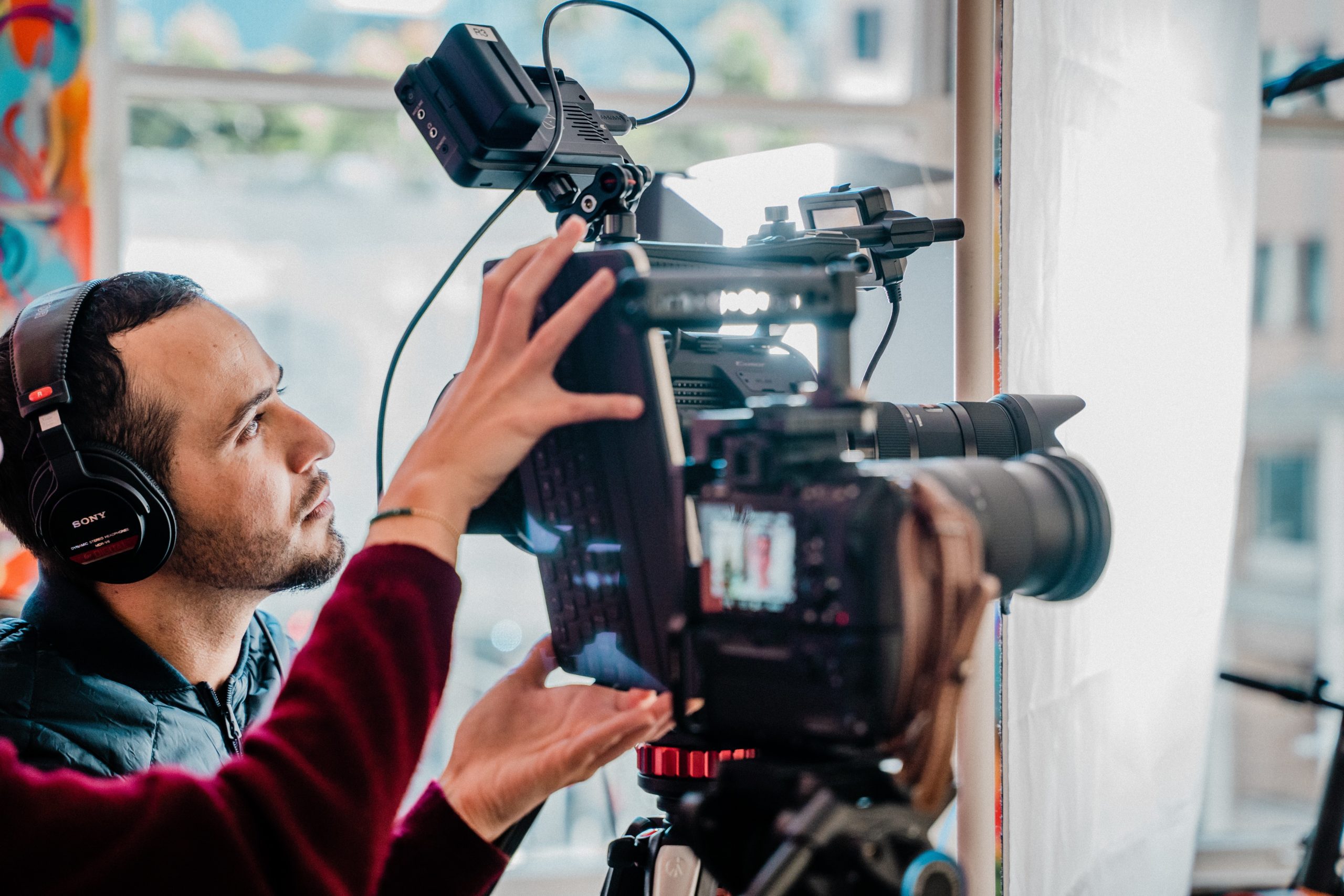 man operating camera on a shoot depicting the different types of video production available